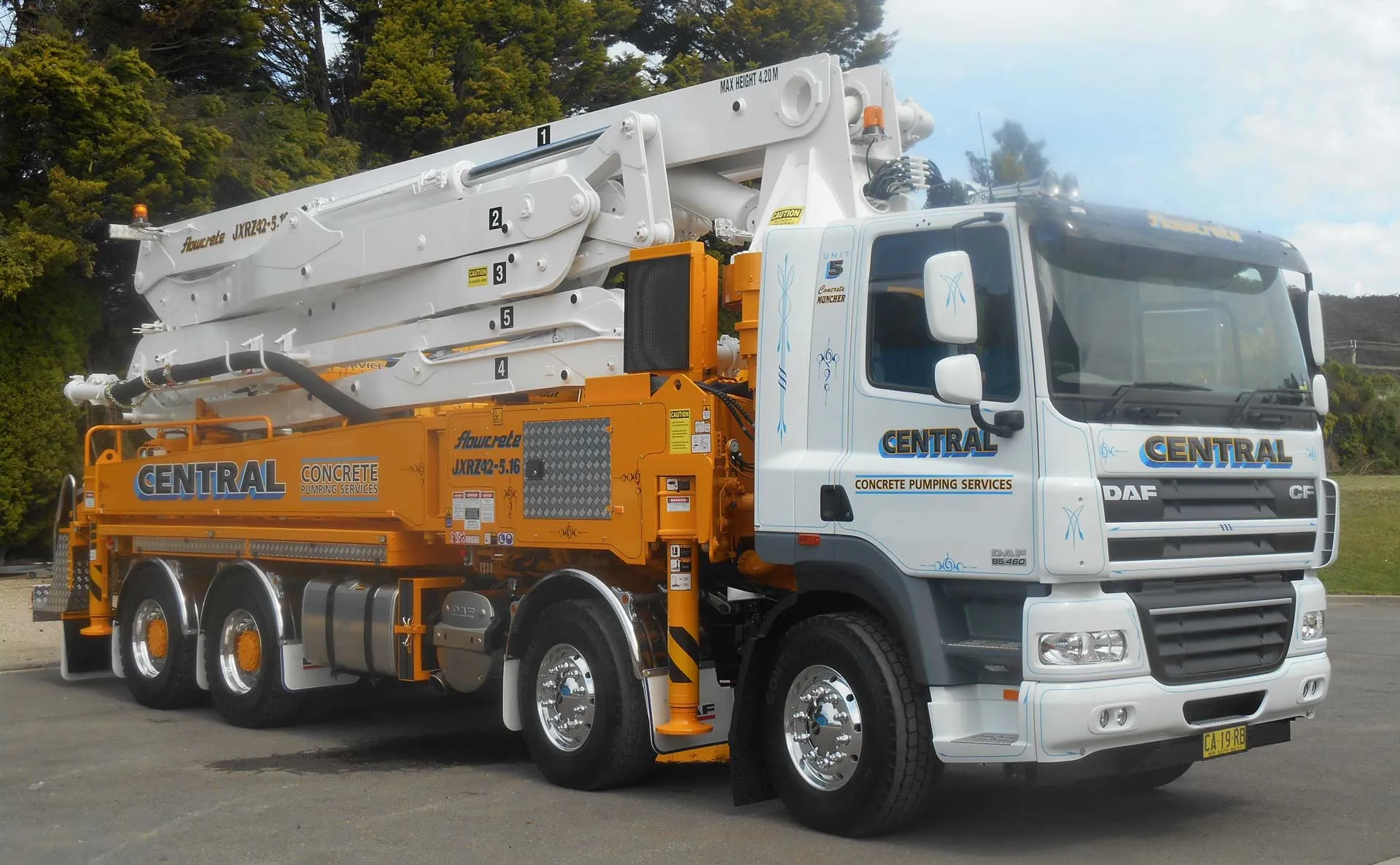 orange and white concrete pumping truck